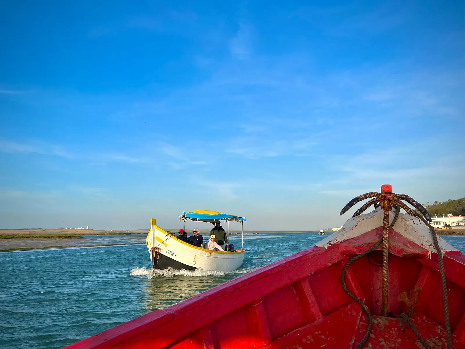 Small boat on the calm water of the Oualidia lagoon, sheltered from the ocean