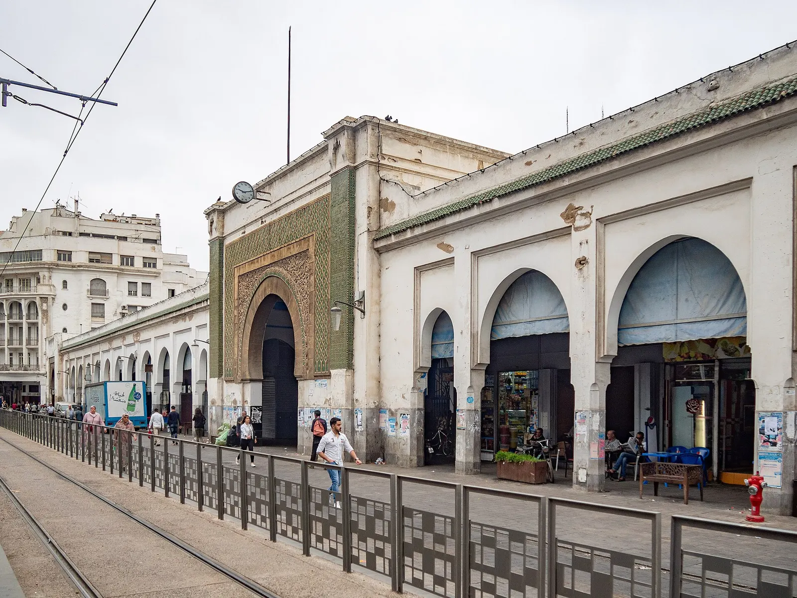 Arched entrance of Casablanca's Central Market on Boulevard Mohammed V, with tram tracks in front