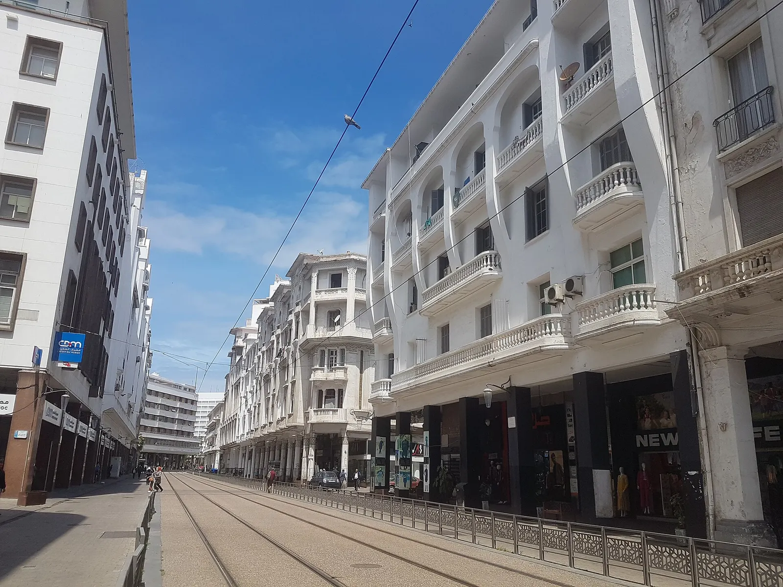 White Art Deco buildings with balconies along Boulevard Mohammed V beside the tram line